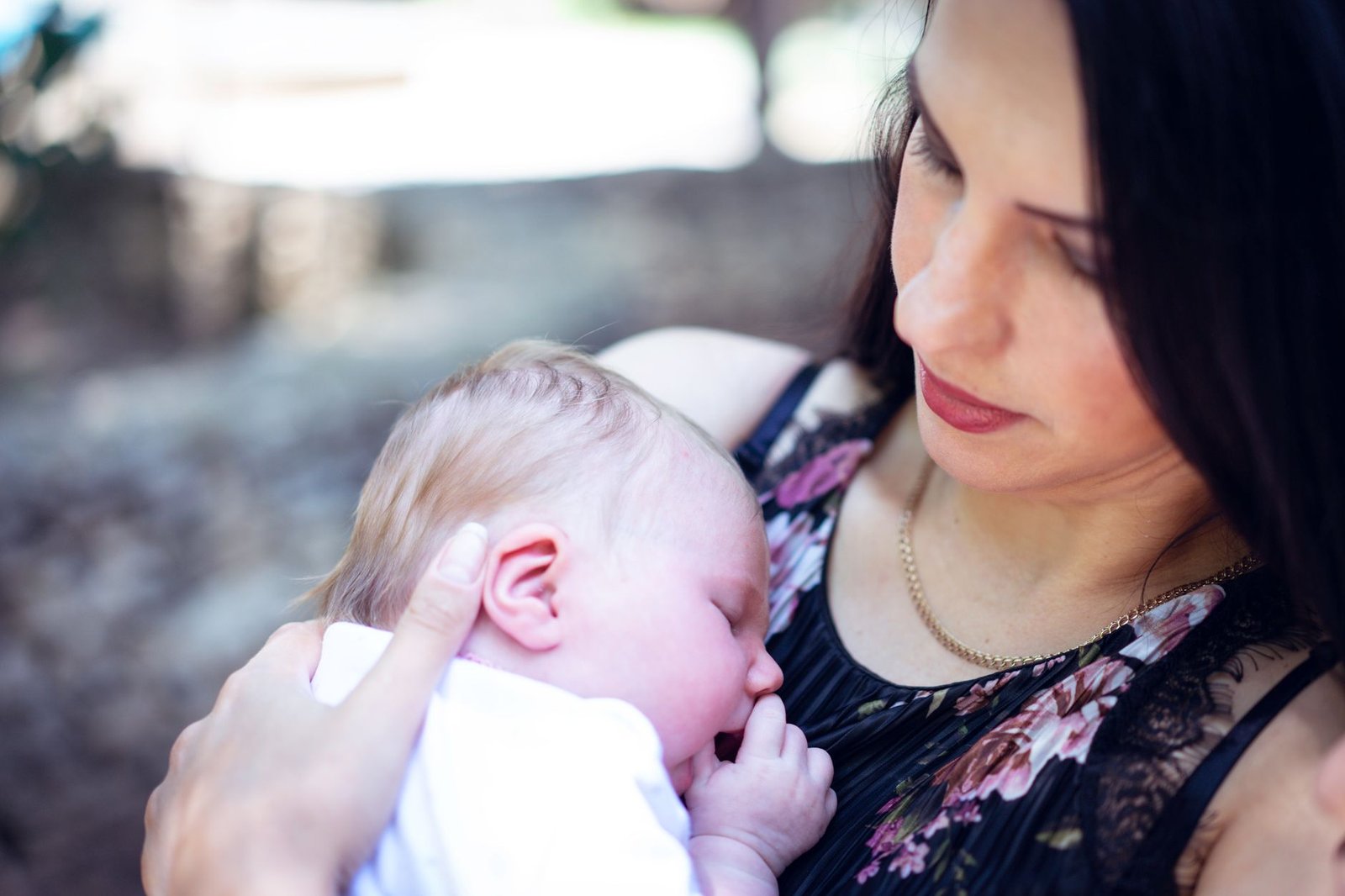 New mom holding baby with Mother's Day card